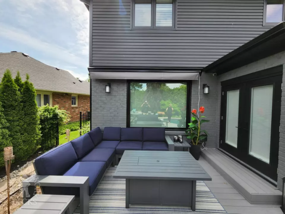 Large grey fiberon deck with a Rolltec awning Large grey fiberon deck with a Rolltec awning