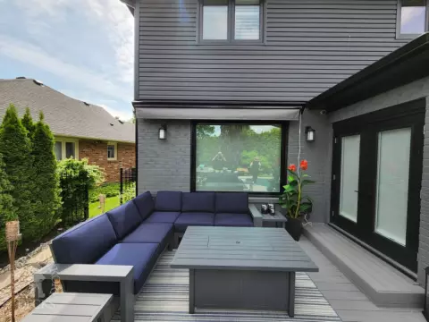 Large grey fiberon deck with a Rolltec awning Large grey fiberon deck with a Rolltec awning