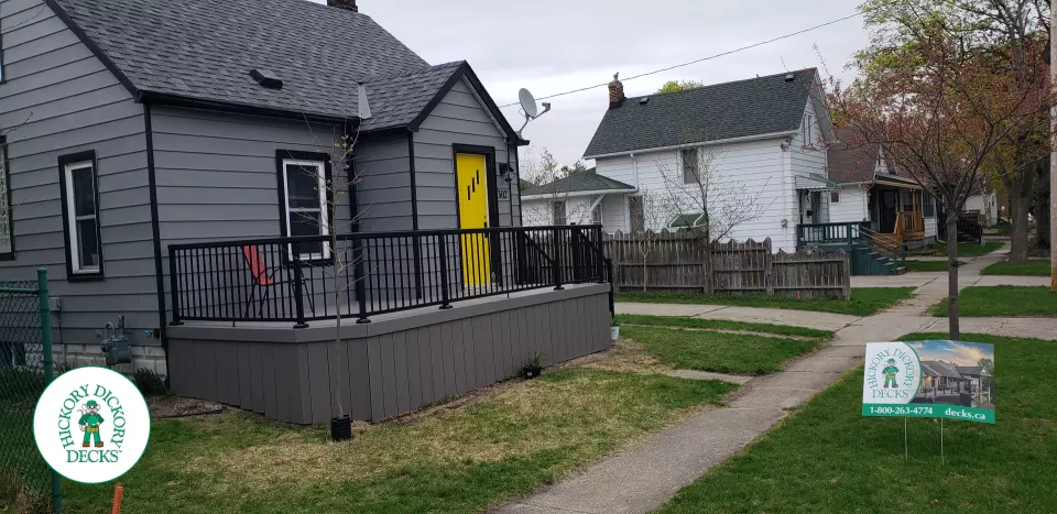 Small grey composite deck with black aluminum railing