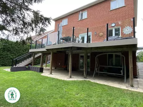 High Deck with stairs in Clay composite with glass railings.