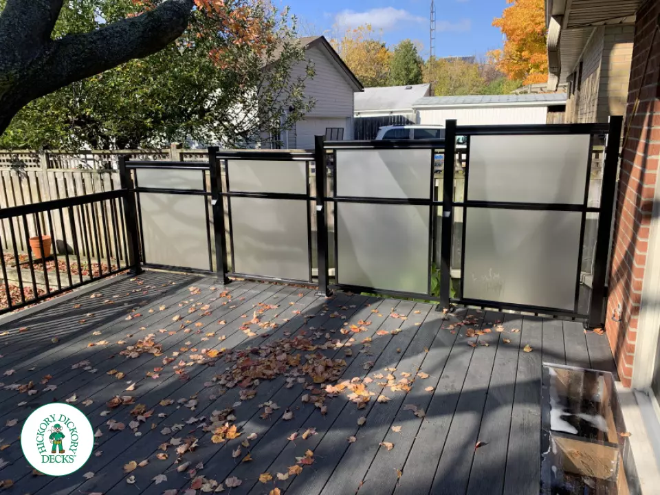 Beautiful Clubhouse deck in colour driftwood built around a tree featuring: aluminum railings and frosted glass privacy screens, Mississauga, Ontario