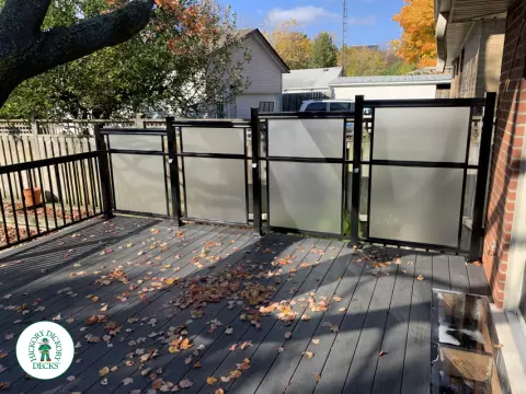 Beautiful Clubhouse deck in colour driftwood built around a tree featuring: aluminum railings and frosted glass privacy screens, Mississauga, Ontario