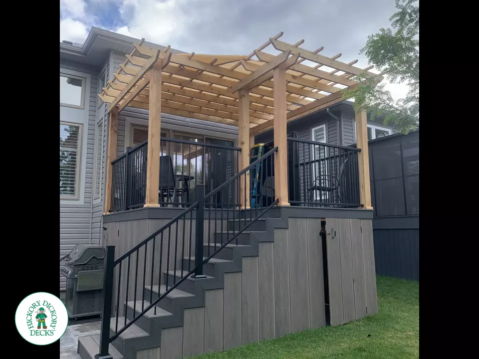 Mid high clubhouse deck with cedar pergola and a dark grey border.