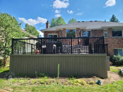 2 level grey composite deck with black aluminum railing.