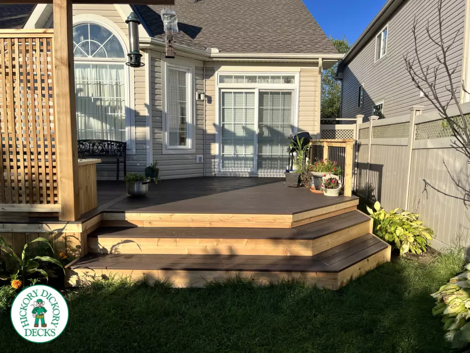 Mid size clubhouse deck in brown with cedar skirt, benches, planters, and a pergola.