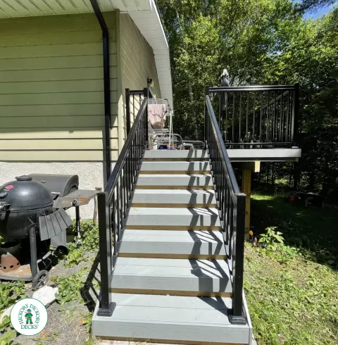Timbertech elevated deck with glass railing and stairs in Gravenhurst