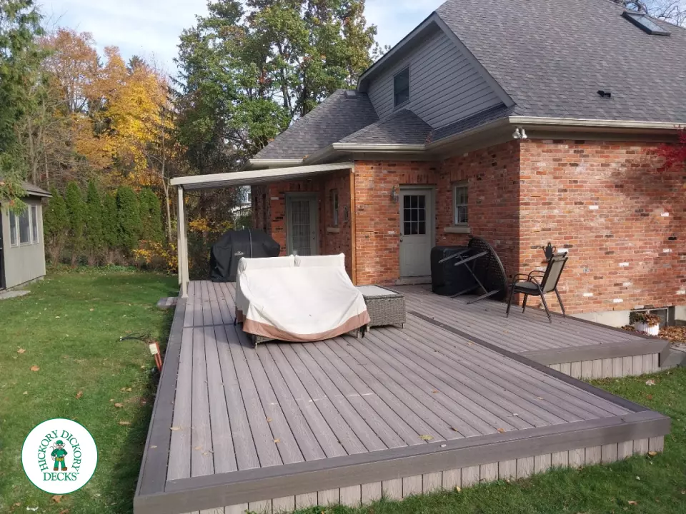 Grey deck with dark grey trim and a sunspace roof structure.
