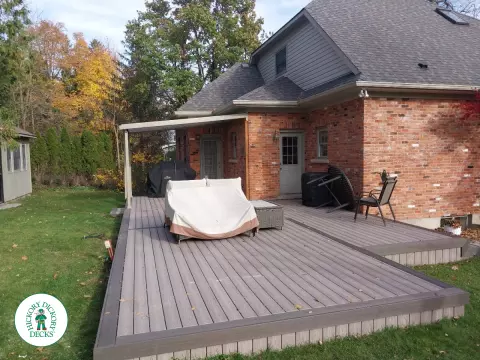 Grey deck with dark grey trim and a sunspace roof structure.