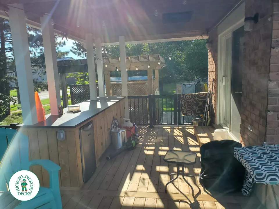 Cedar deck with roof structure that has a built in bar, and aluminum railings with a gate insert.