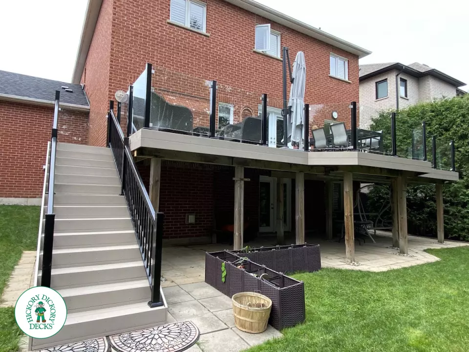 High Deck with stairs in Clay composite with glass railings.