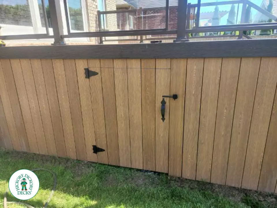 Small landing outside back door with stairs and glass railing.