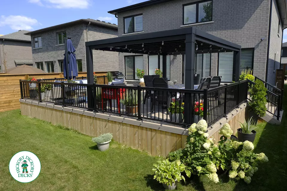 Large grey Fiberon walk out deck with black aluminum railings in Ancaster