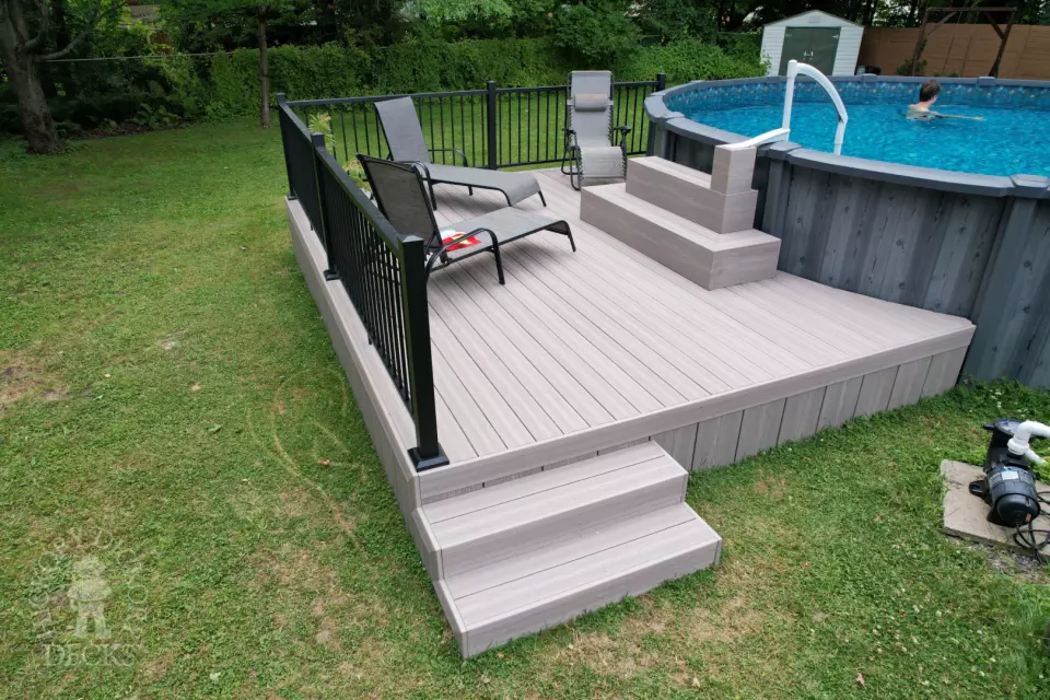 Small grey fiberon deck built around an above ground pool.