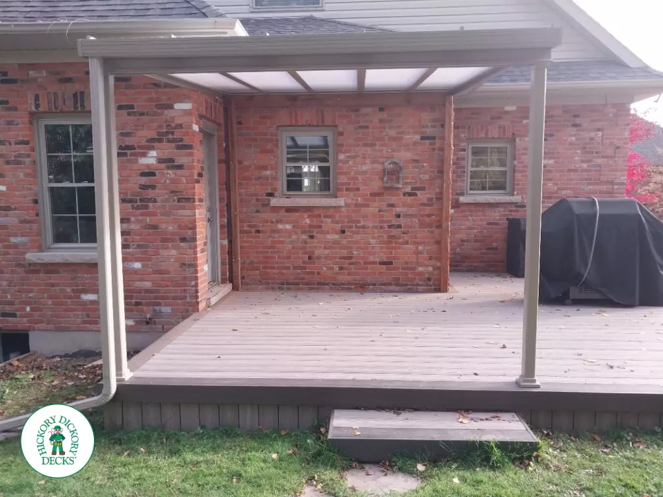 Grey deck with dark grey trim and a sunspace roof structure.