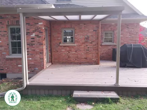 Grey deck with dark grey trim and a sunspace roof structure.