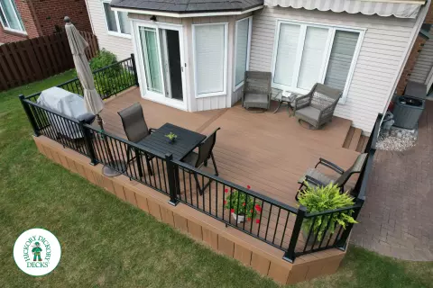 LArge brown fiberon deck with black aluminum railings.