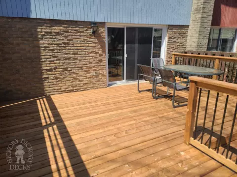 Low cedar deck with picket cedar railings and a cedar privacy screen.