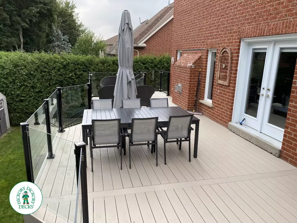 High Deck with stairs in Clay composite with glass railings.