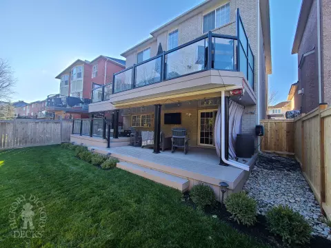 Azek high deck with glass railings and spiral stairs in Brampton