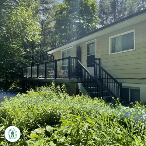 Timbertech elevated deck with glass railing and stairs in Gravenhurst Timbertech elevated deck with glass railing and stairs in Gravenhurst