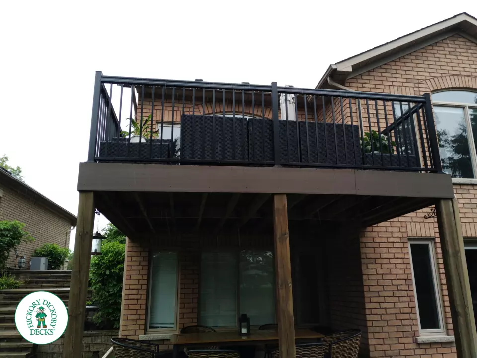 High brown azek deck with black railing.