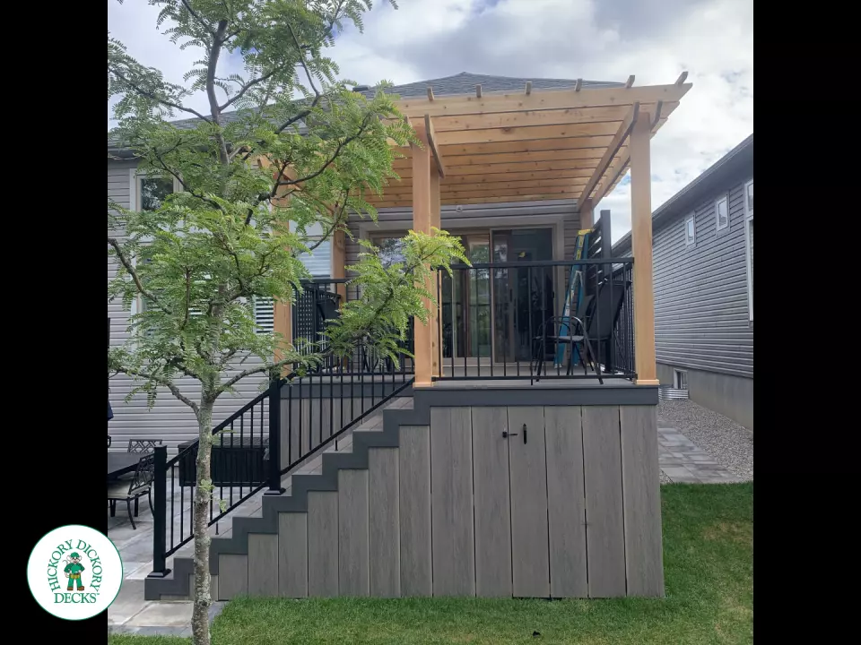 Mid high clubhouse deck with cedar pergola and a dark grey border.
