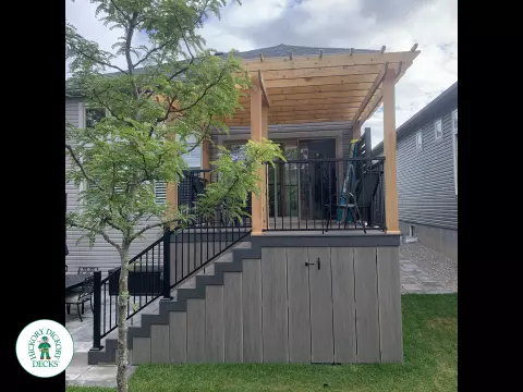 Mid high clubhouse deck with cedar pergola and a dark grey border.
