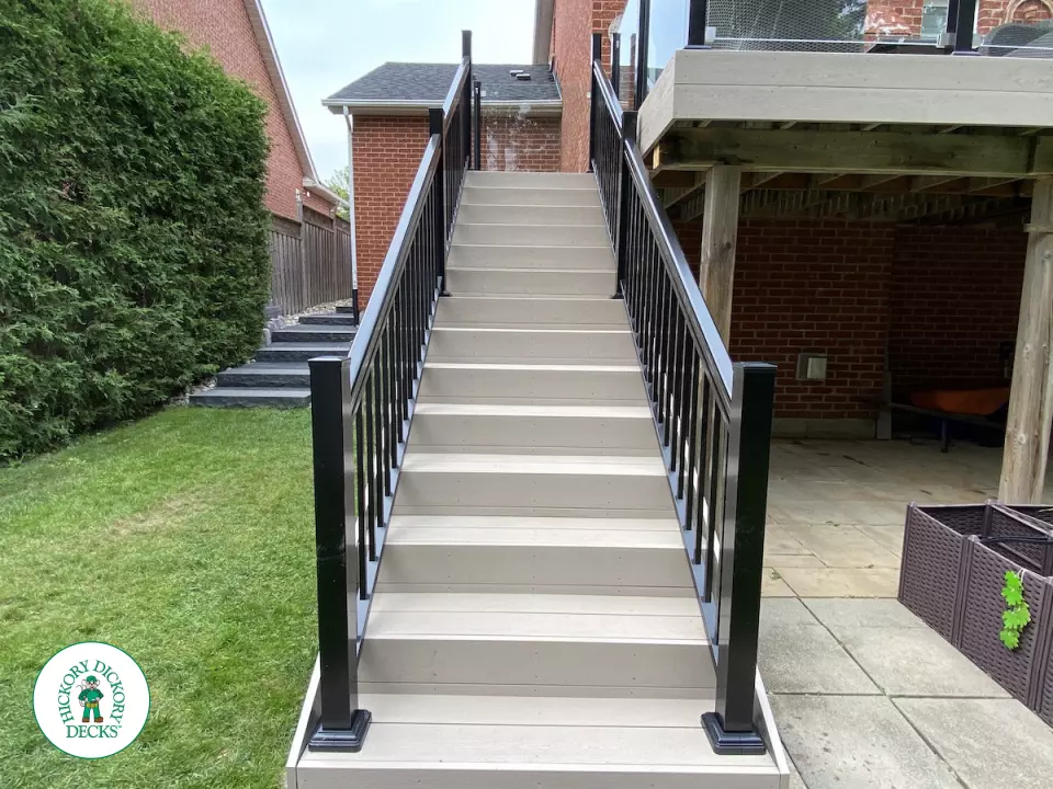 High Deck with stairs in Clay composite with glass railings.