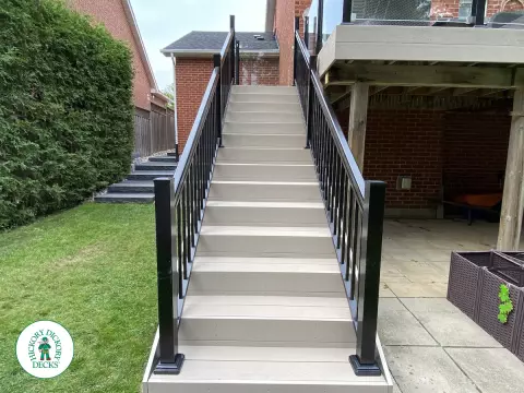High Deck with stairs in Clay composite with glass railings.