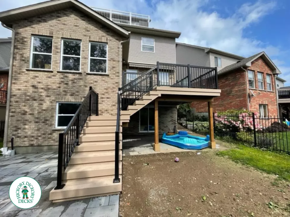 High rise Azek deck in beige color with unique steps and black railing.