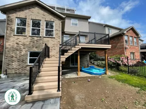 High rise Azek deck in beige color with unique steps and black railing.