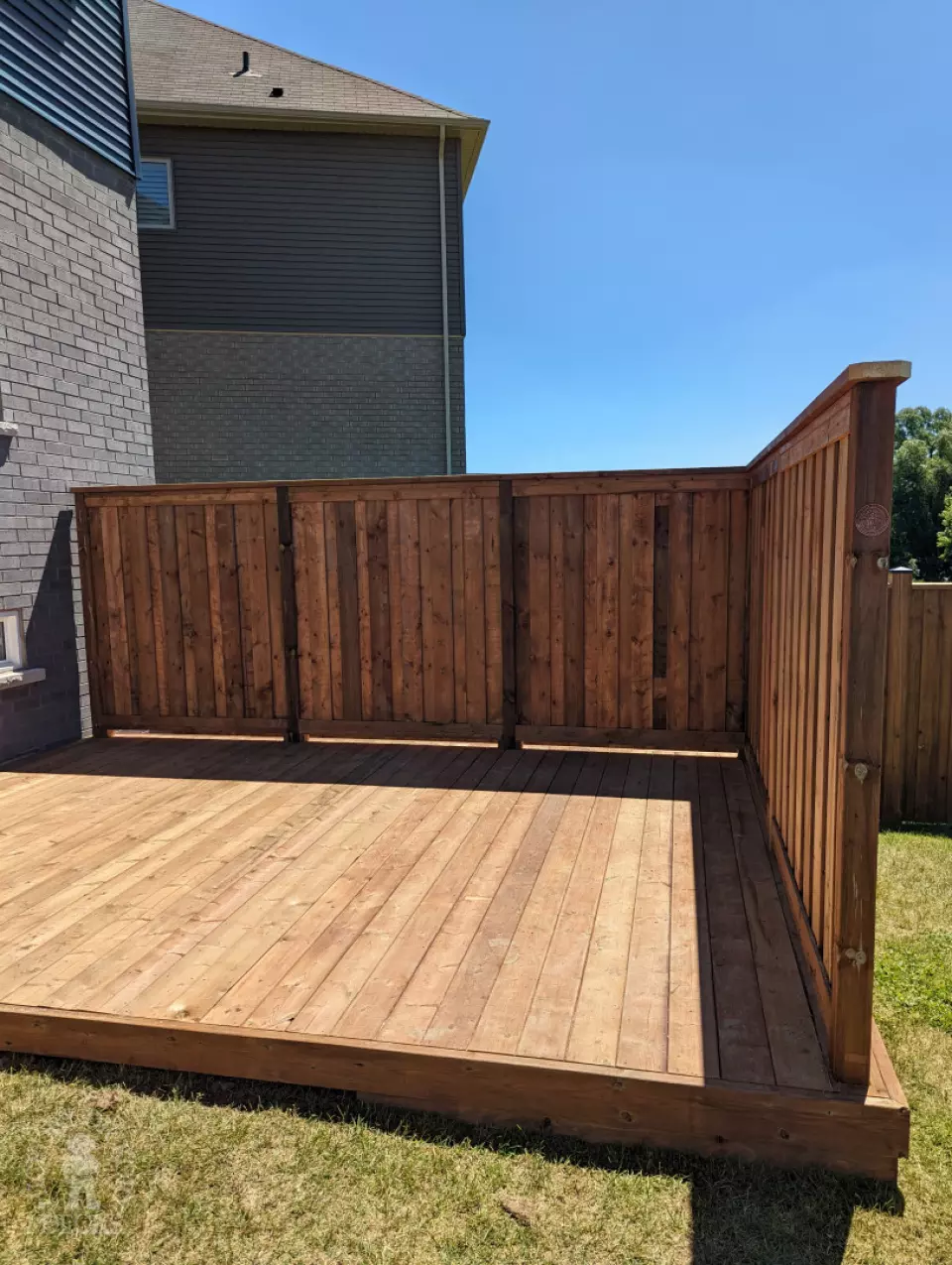Pressure treated deck with pressure treated privacy screens and fence.