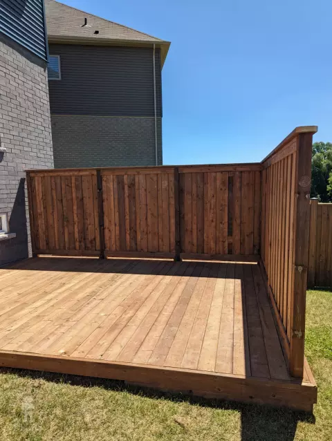 Pressure treated deck with pressure treated privacy screens and fence.
