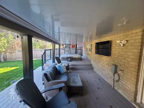 Azek high deck with glass railings and spiral stairs in Brampton
