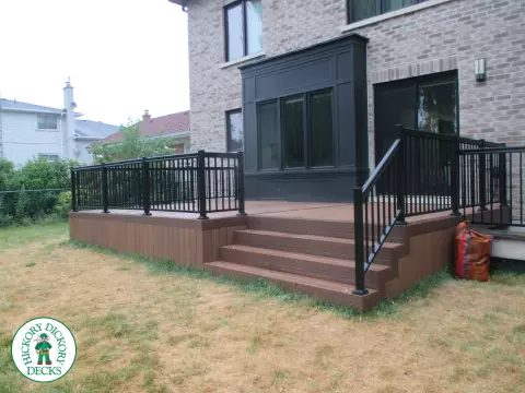 Low brown composite deck with black aluminum railing