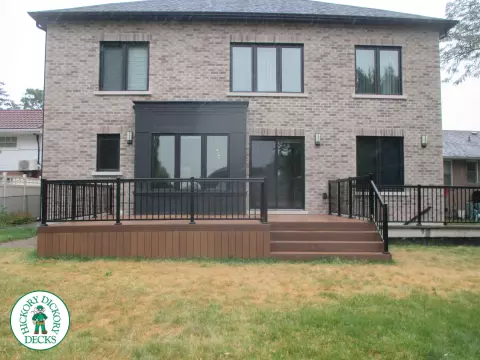 Low brown composite deck with black aluminum railing