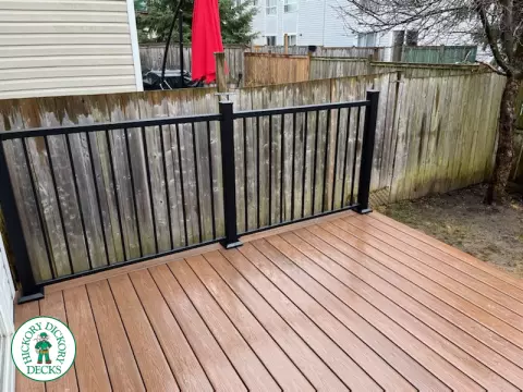 Small brown fiberon deck with black aluminum railing.