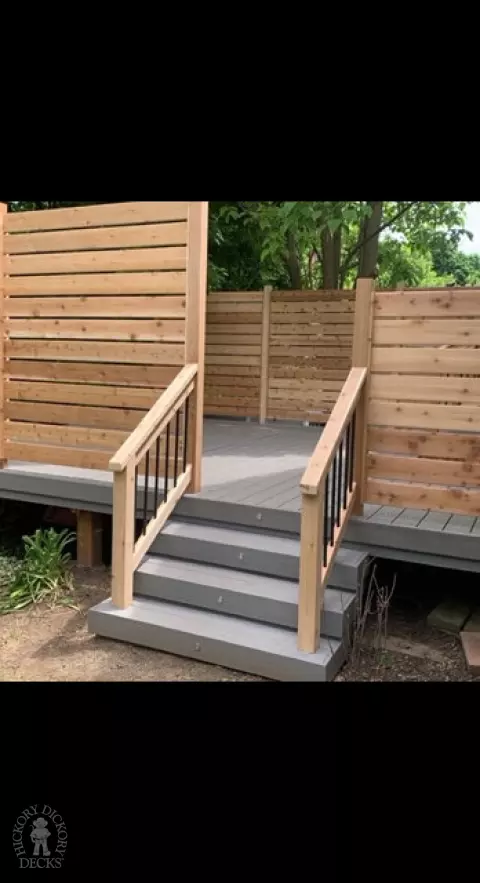 Grey fiberon deck with cedar railing and a cedar privacy screen.