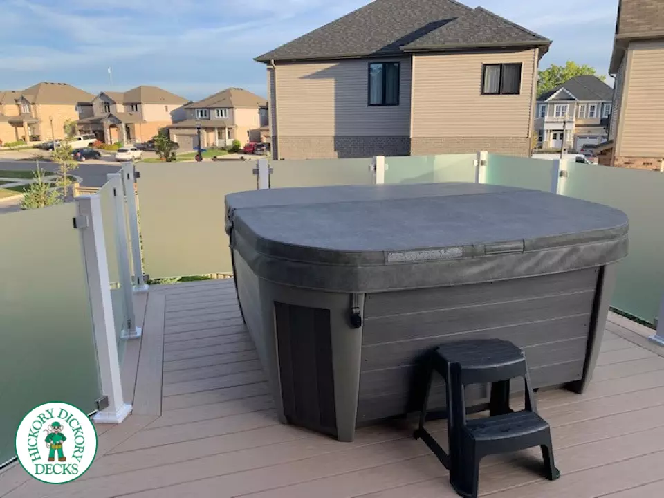 Large high Azek deck with frosted glass privacy screen.