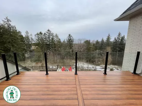High brown composite deck with glass railings