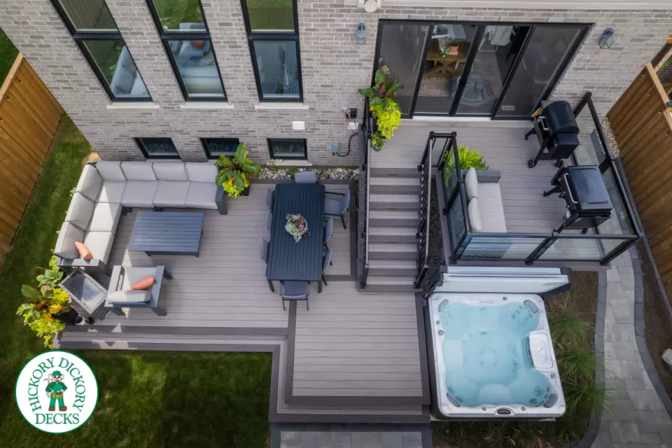 2 level brown composite deck with unique stairs and black aluminum railing. in Waterloo