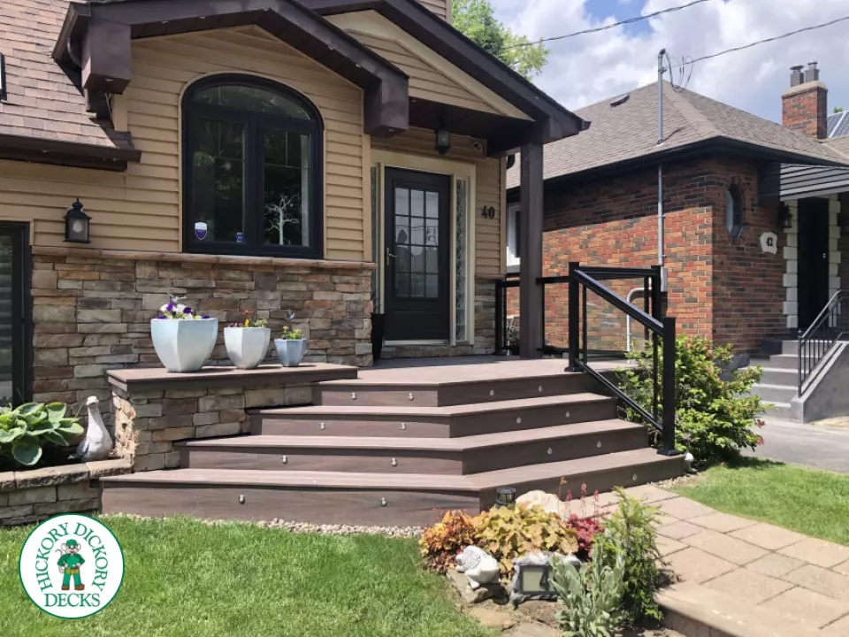 Brown porch with angled steps with lighting.