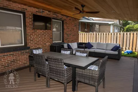 Small low brown composite deck with a dark brown border. and a custom roof structure.