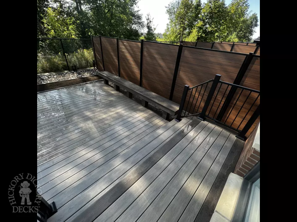 Grey Clubhouse deck with dark grey border, lighting in steps, and a custom bench.