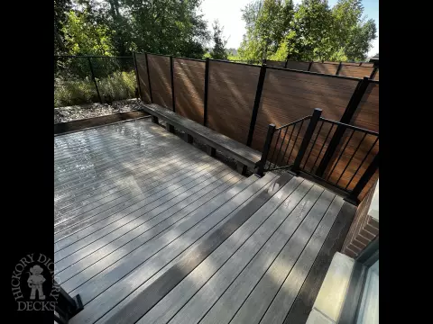 Grey Clubhouse deck with dark grey border, lighting in steps, and a custom bench.