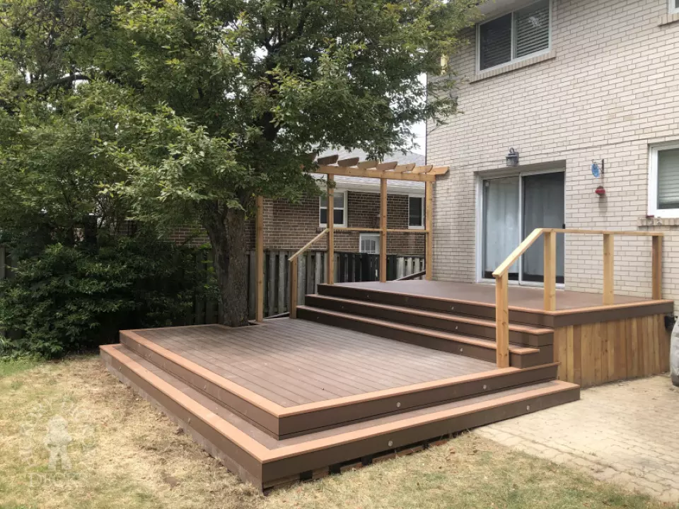 TruNorth deck with Mocha Caramel trim, wraparound steps, lights and a pergola, built around a tree. Etobicoke, Ontario