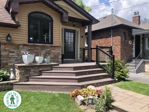 Brown porch with angled steps with lighting.