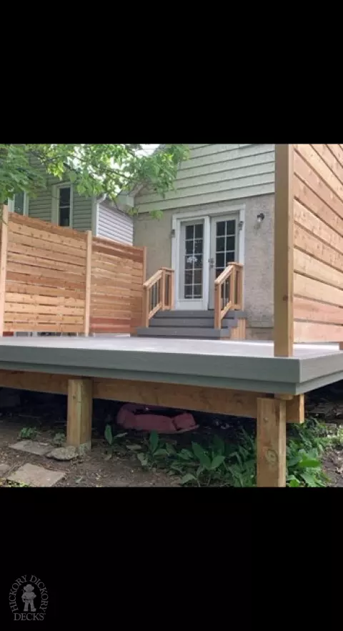 Grey fiberon deck with cedar railing and a cedar privacy screen.