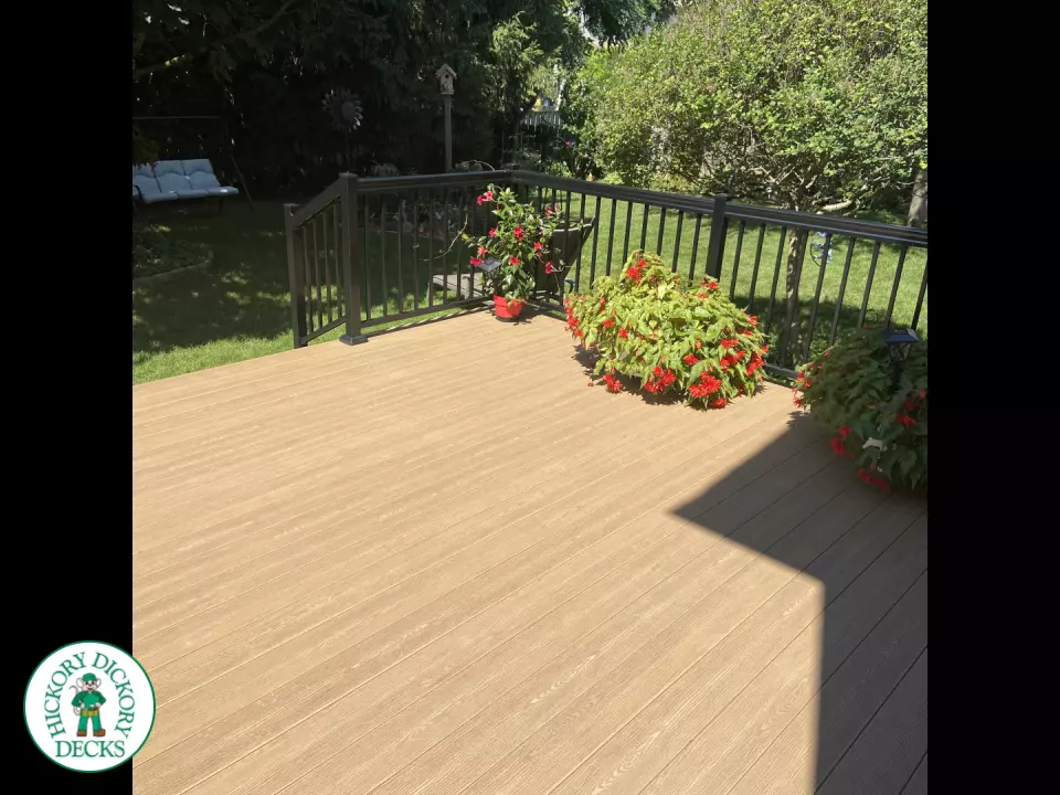 3 steps leading to small brown clubhouse deck with black aluminum railing.