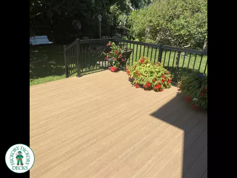 3 steps leading to small brown clubhouse deck with black aluminum railing.
